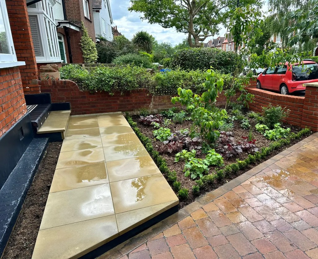 Yorkstone entrance pathway beside a permeable block driveway in Dulwich.
