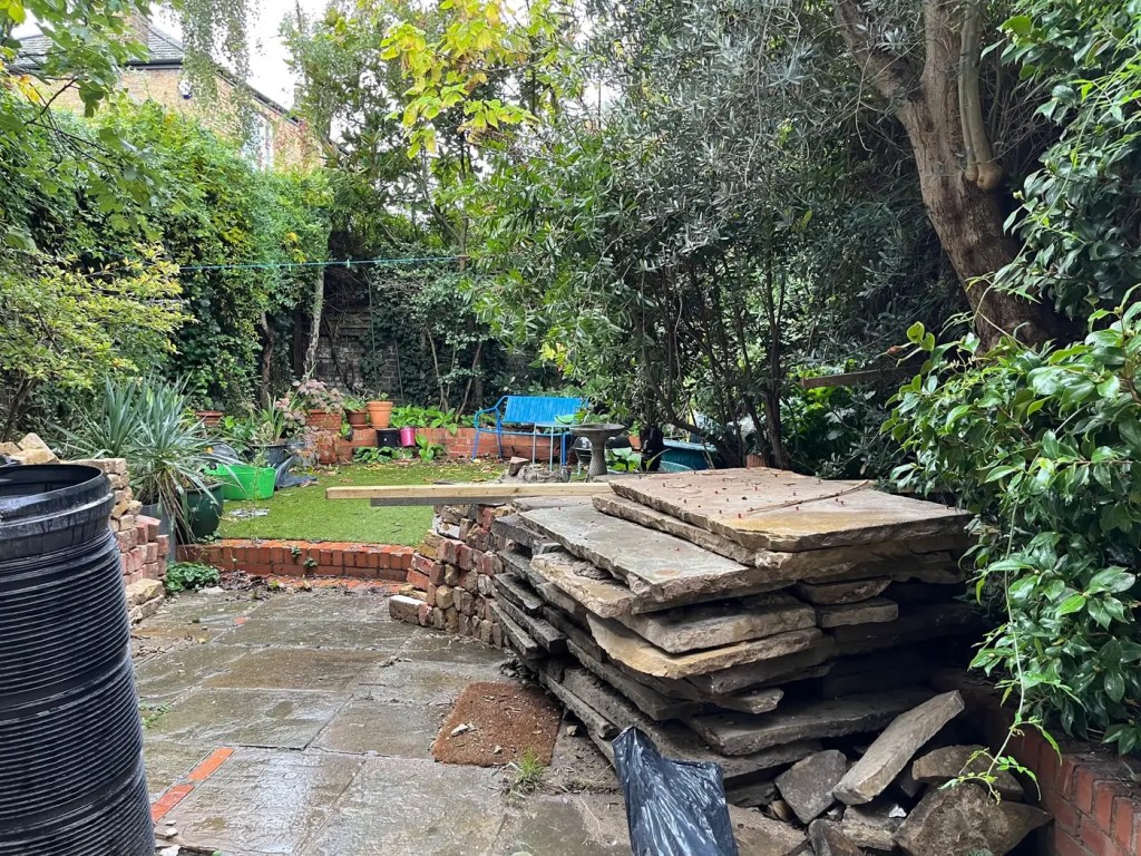Original paving, materials and changing levels in the Lewisham garden before landscaping.