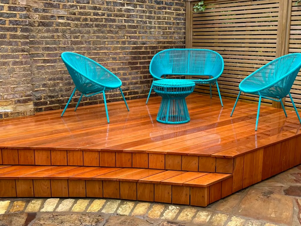 Raised timber decking used as an outdoor seating area with integrated steps.