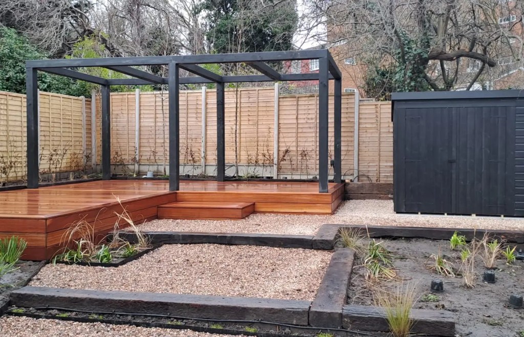 Bespoke timber decking with steps and a garden structure in South London.